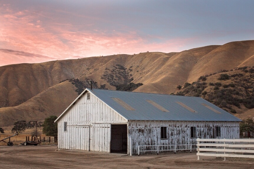 An original barn on the Tejon Ranch land with mountains in the background
