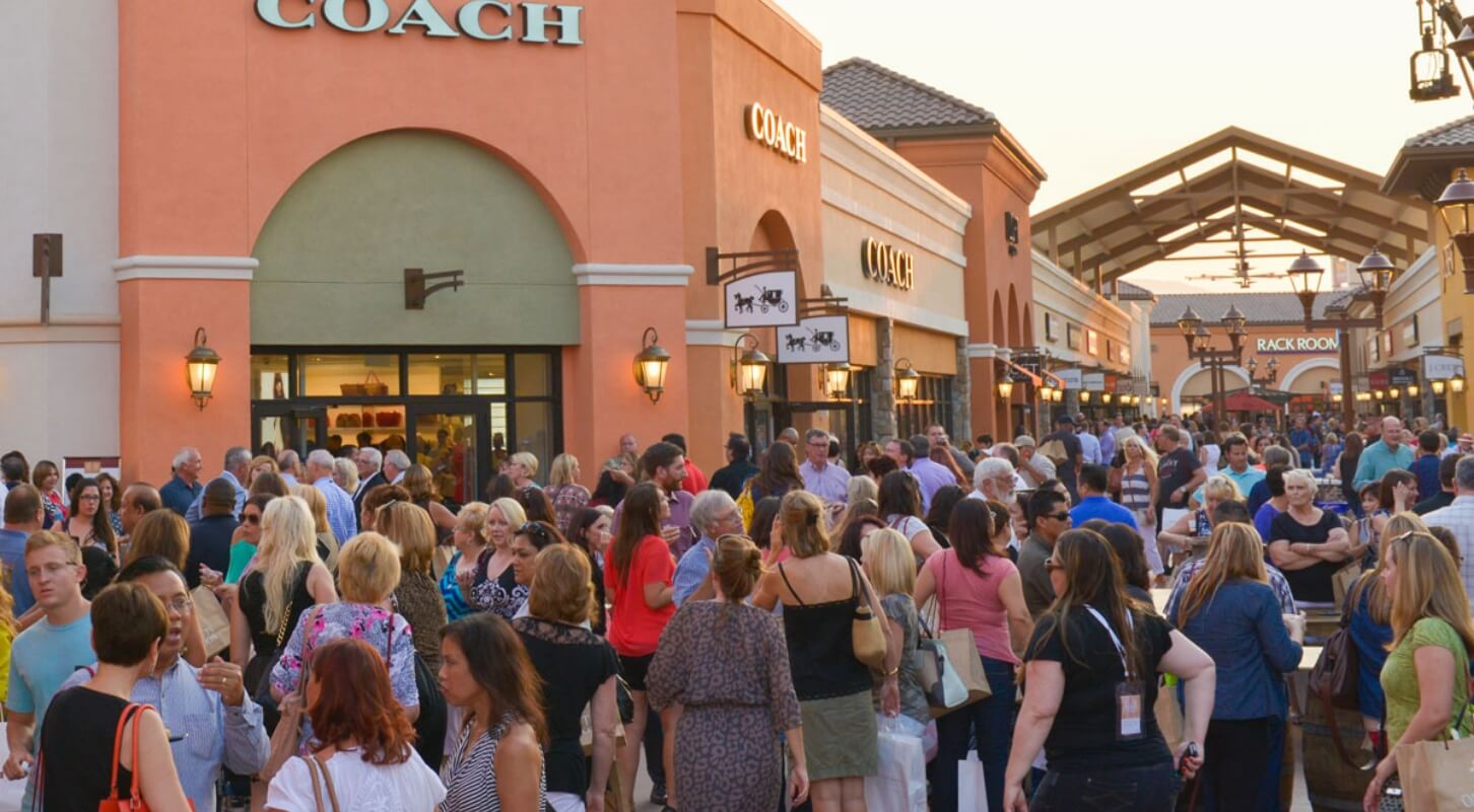 People gathered outside of a shop at The Outlets at Tejon