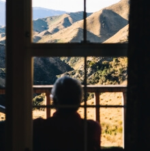 A man gazes out from the porch at the breath-taking topography found at Tejon Ranch